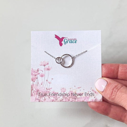 double circle necklace in silver on a necklace card that reads true friendship never ends