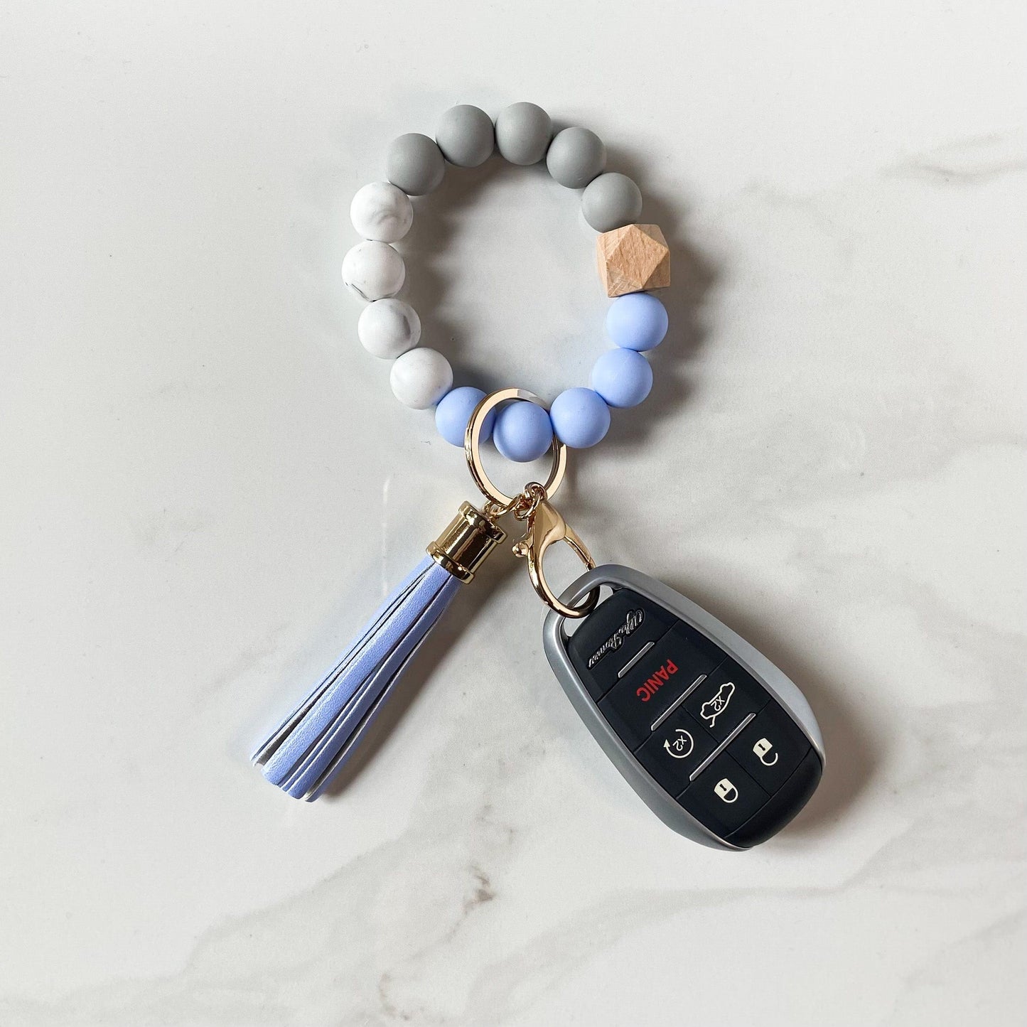 blue bracelet keychain with car keys